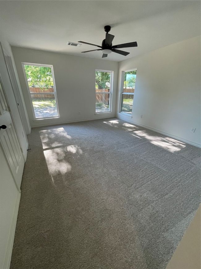 Carpeted Primary bedroom overlooking backyard oasis. Featuring lots of light & 4" baseboards | Image 7
