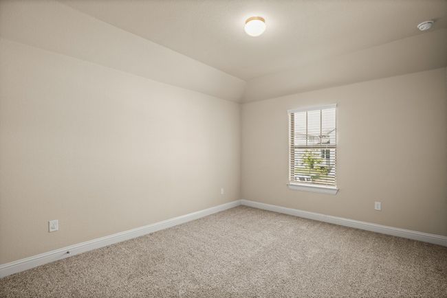 Empty room with baseboards, light carpet, and lofted ceiling | Image 22