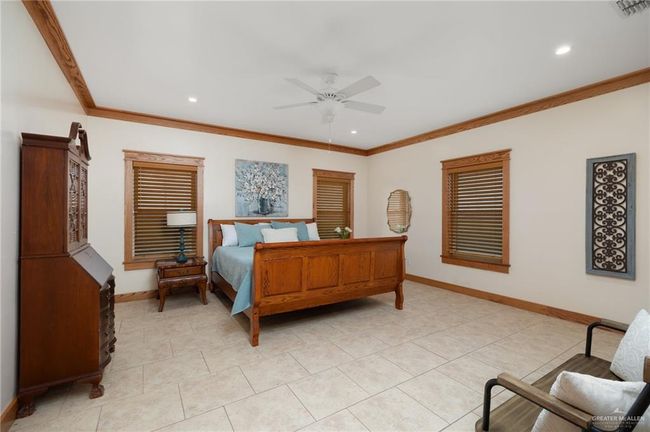 Tiled bedroom featuring ceiling fan and crown molding | Image 20