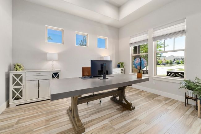 Office area with light wood-style flooring, coffered ceiling and double door entry | Image 12