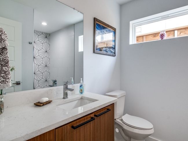Bathroom featuring toilet and vanity | Image 16