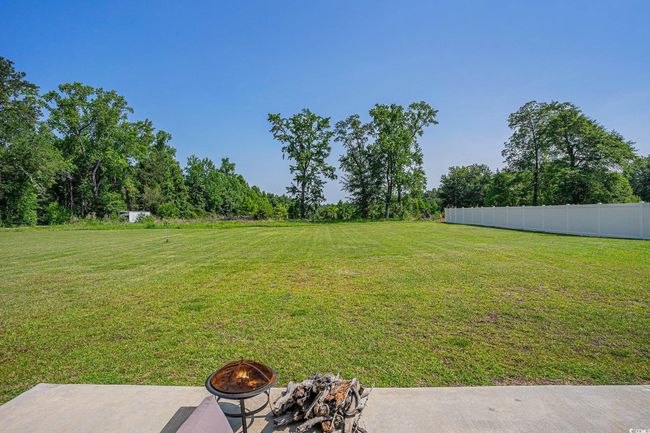 View of yard with an outdoor fire pit | Image 27