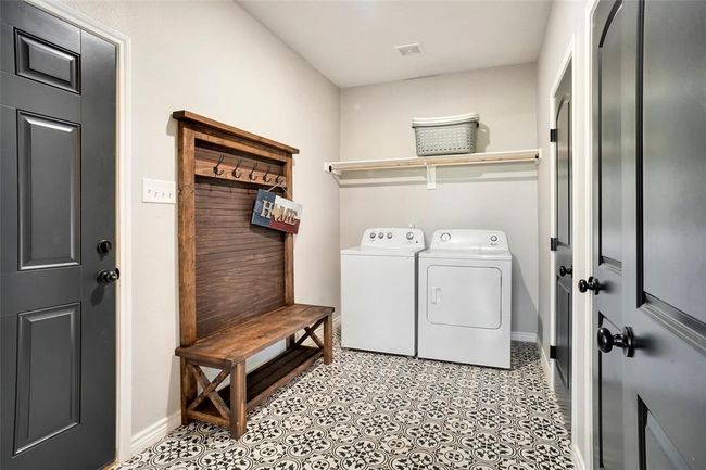 Laundry room with washer and dryer and light tile floors | Image 31