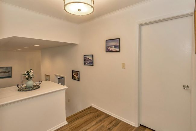 Hallway with wood finished floors, baseboards, and ornamental molding | Image 12