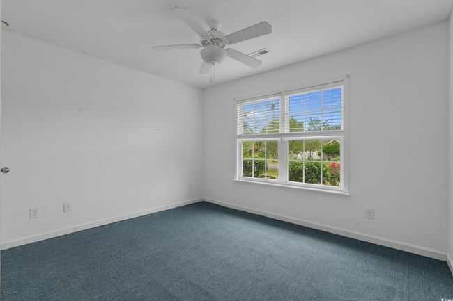 Unfurnished room featuring carpet, baseboards, and ceiling fan | Image 34