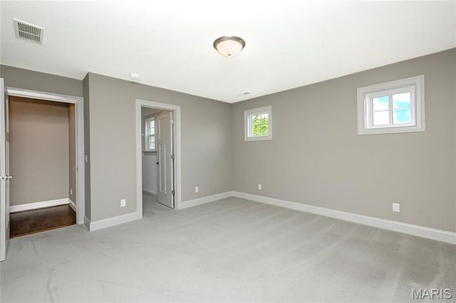 Upstairs bedroom featuring baseboards, light colored carpet, walk-in closet | Image 40