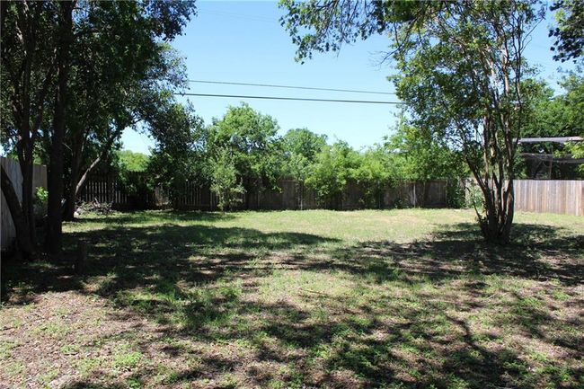 View of fenced backyard | Image 21
