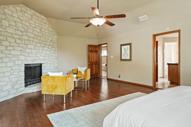 Limestone floor to ceiling fireplace in primary bedroom | Image 11