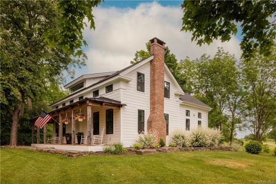 Rear view of property featuring a yard | Image 2