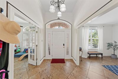 Tiled entryway with a notable chandelier and crown molding | Image 3