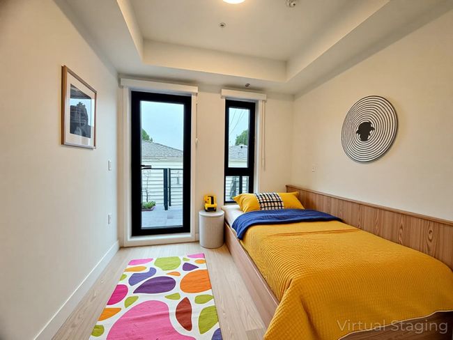 Bedroom featuring access to outside, a tray ceiling, and wood finished floors | Image 31