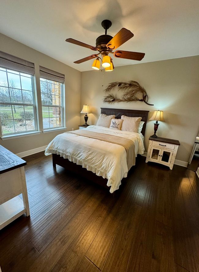 Bedroom featuring baseboards, ceiling fan, and dark wood-type flooring | Image 17