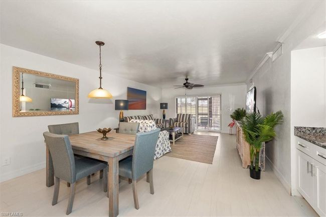 Dining area with ceiling fan and baseboards | Image 11