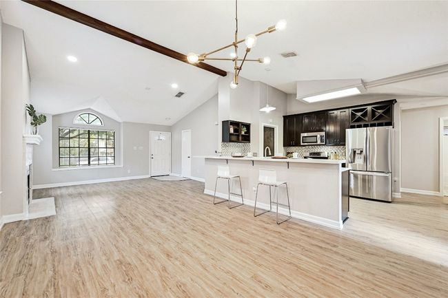 Large, eat-in kitchen with a bar that will easily fit 4+ barstools. | Image 8