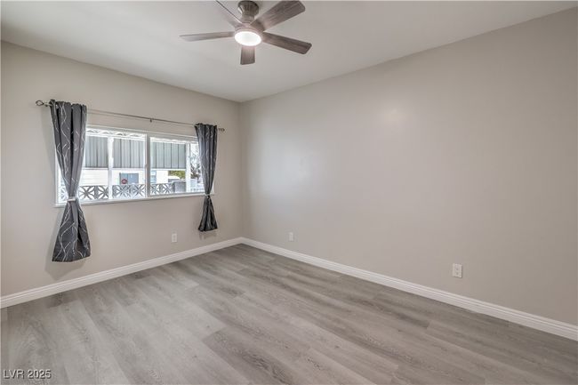 Unfurnished room with ceiling fan, baseboards, and wood finished floors | Image 24