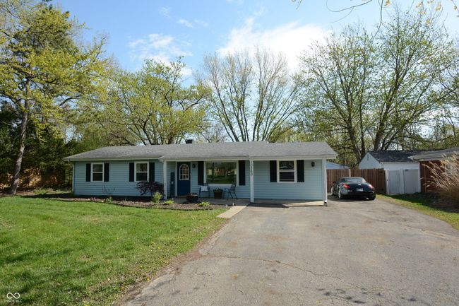 ranch-style house featuring fence, aphalt driveway, covered porch, and a front yard | Image 49