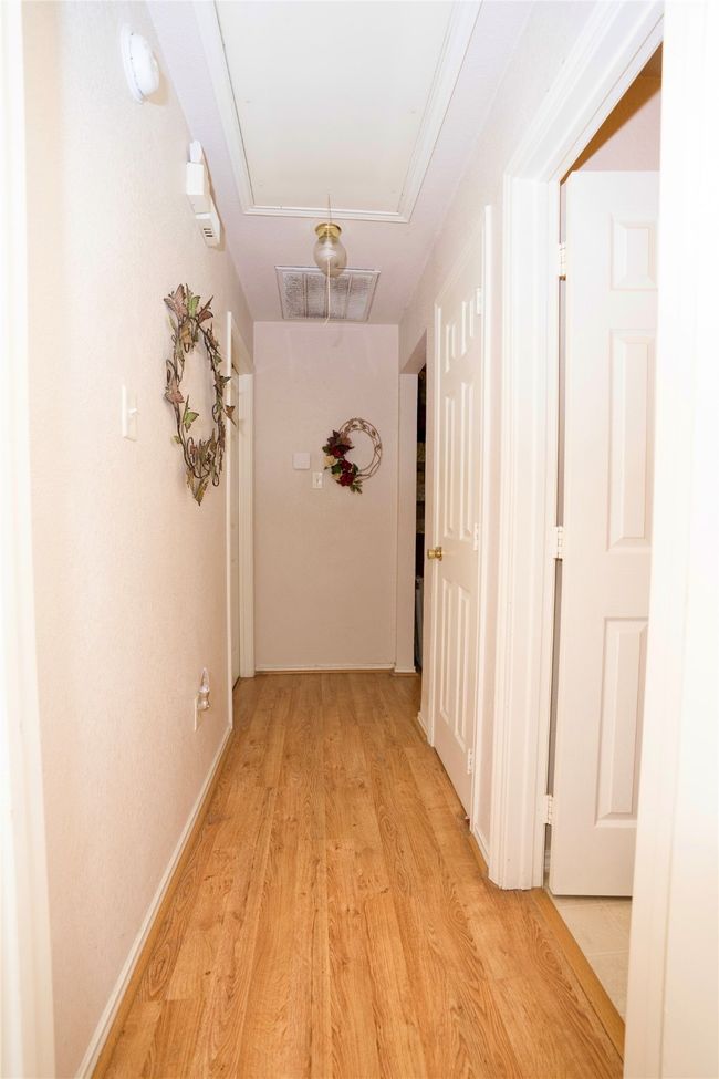 Hallway with attic access and light wood finished floors | Image 18