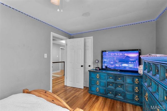Bedroom featuring wood finished floors and a closet | Image 16