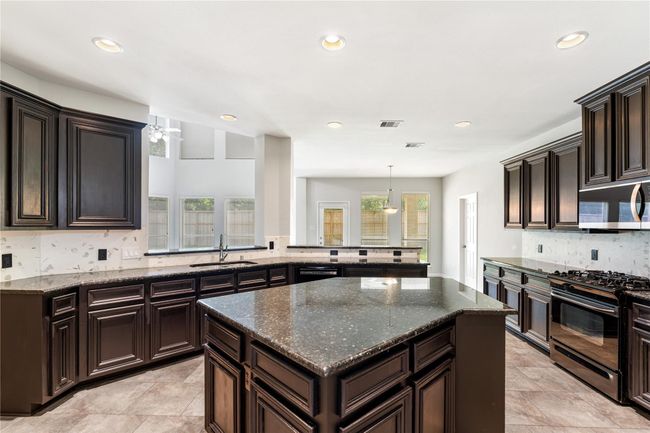 Beautiful kitchen with tons of cabinetry and upgraded appliances including LG Microwave and Bosch Dishwasher | Image 10