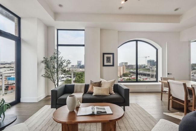 Living area with a tray ceiling, a view of city, and a wealth of natural light | Image 4