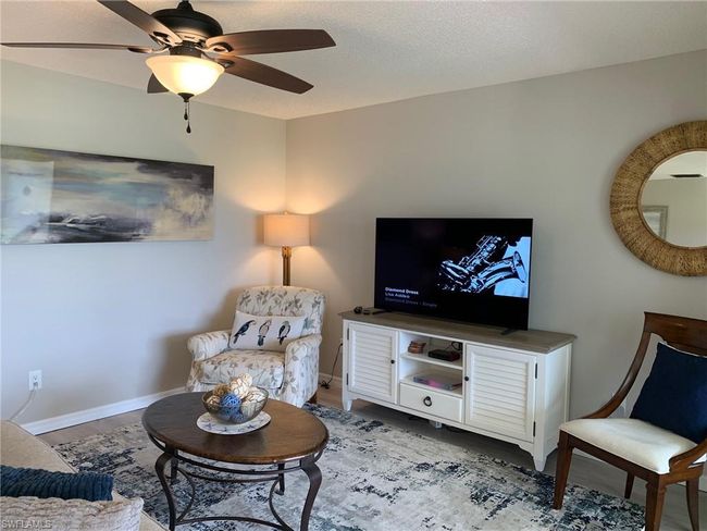 Living room featuring ceiling fan and wood finished floors | Image 5