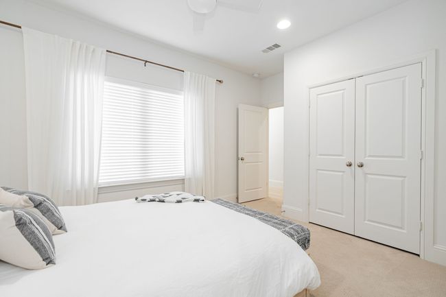 Bedroom featuring a closet, a ceiling fan, recessed lighting, and light carpet | Image 29