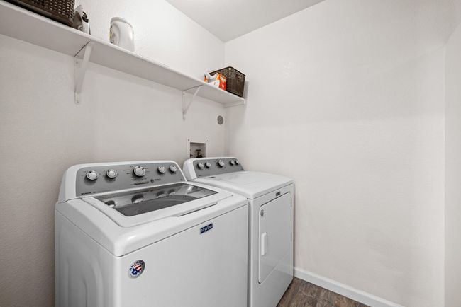 The dedicated laundry room and oversized walk-in pantry are located just off of the kitchen and breakfast area with plenty of space for daily tasks. | Image 32