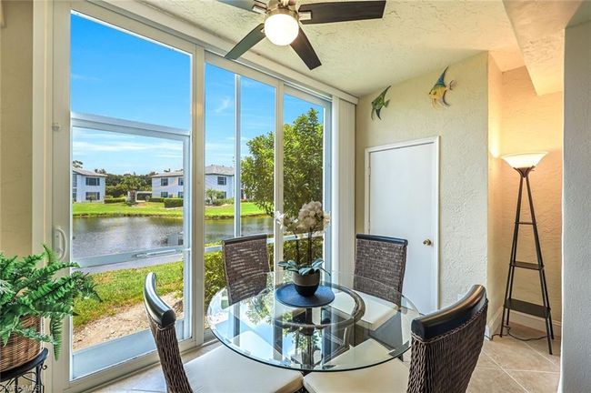 Sunroom with a water view and a ceiling fan | Image 10