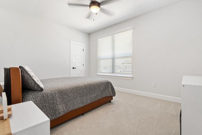 Carpeted bedroom featuring baseboards and a ceiling fan | Image 19