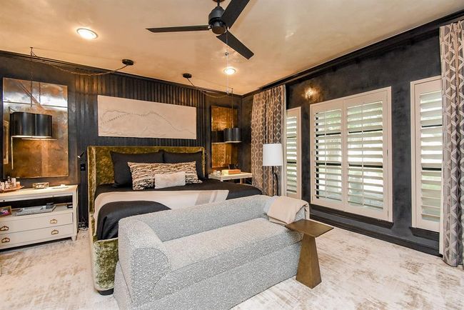 Welcome to the spacious Primary Suite! This is a must see! beautifully appointed with custom plantation shutters, drapes, carpet, lighting, and paint, your personal oasis! | Image 25