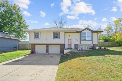 Split foyer home with a front yard and a garage | Image 1