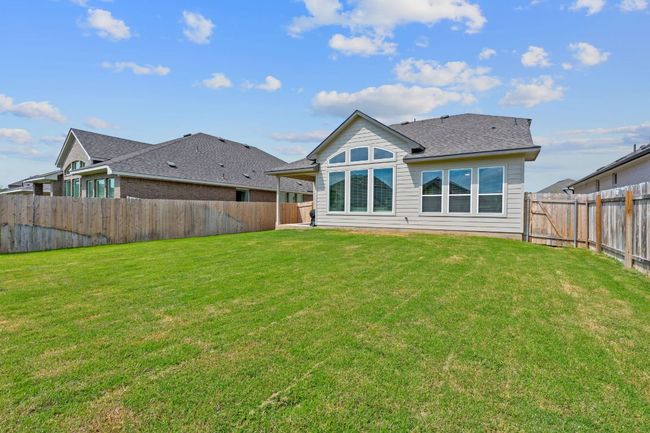 Rear view of property with a yard, a shingled roof, and a fenced backyard | Image 28