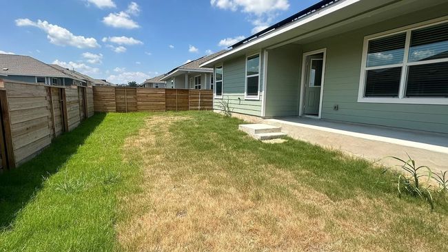 Fenced backyard with a patio | Image 35