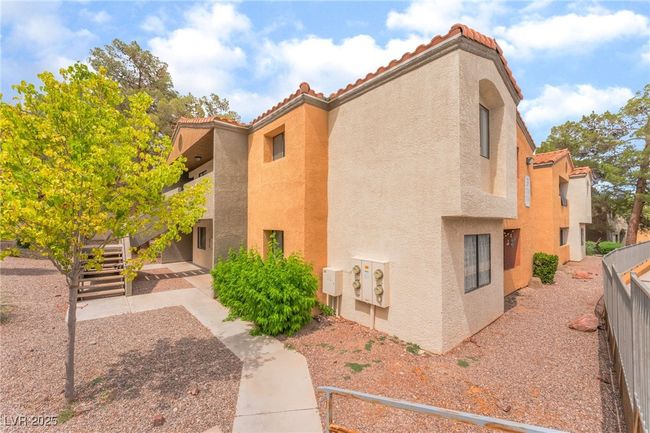 View of side of property featuring stucco siding and a tiled roof | Image 33