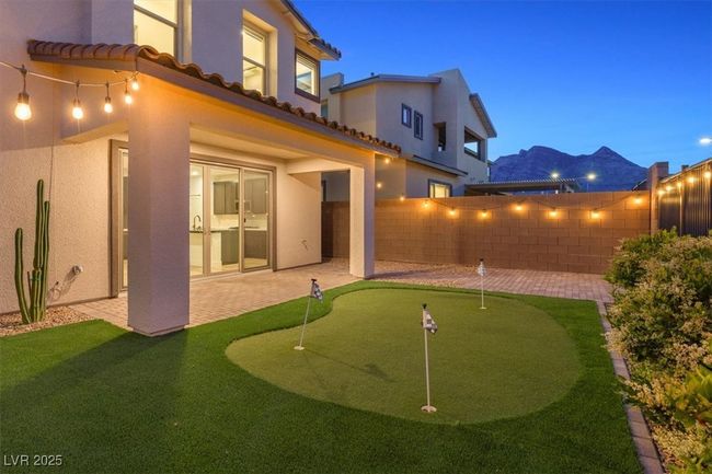 Back of property featuring stucco siding, a tiled roof, a patio, and a fenced backyard | Image 56