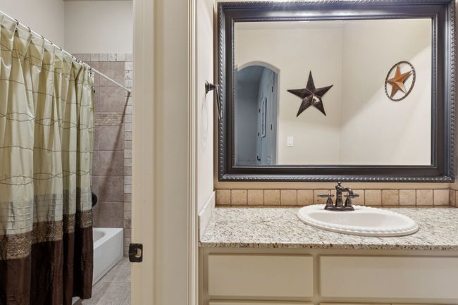 Full bathroom featuring Granite counter top vanity and shower / bathtub combination | Image 21