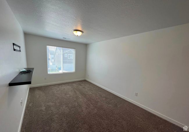 Spare room with a textured ceiling and carpet | Image 9