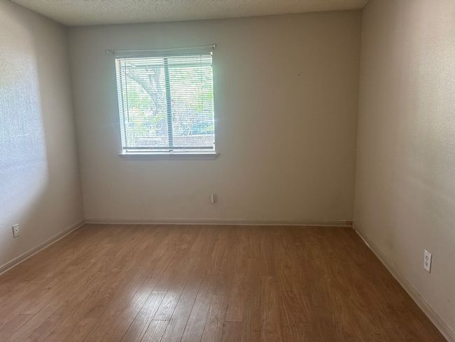 Spare room with light wood finished floors and a textured ceiling | Image 8