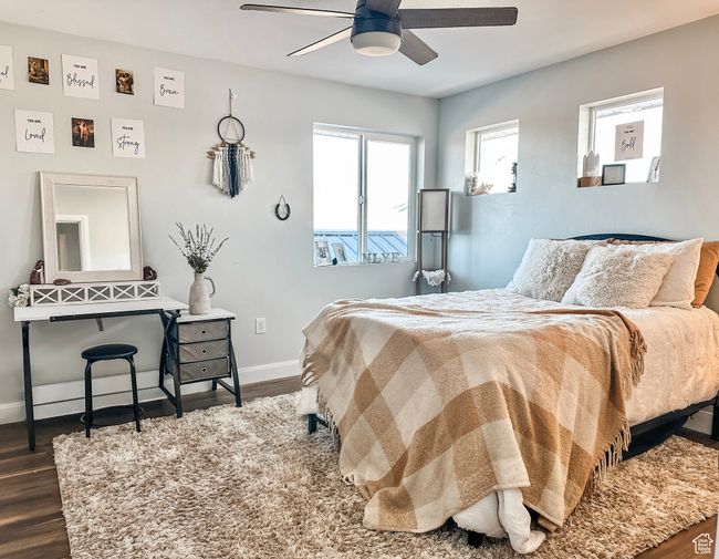 Bedroom featuring baseboards, a ceiling fan, and dark wood-style flooring | Image 22