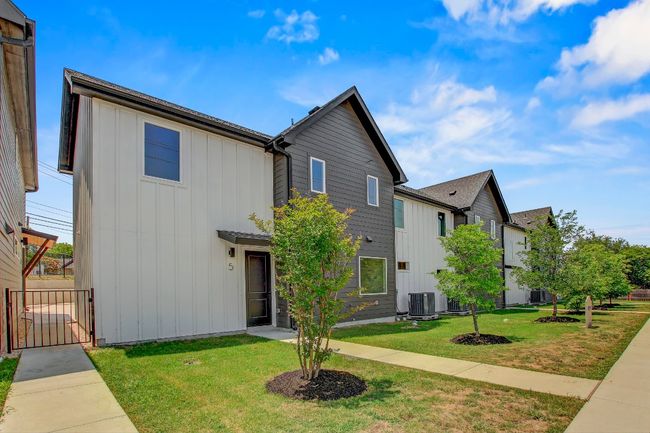 View of front of property with board and batten siding and central AC unit | Image 33