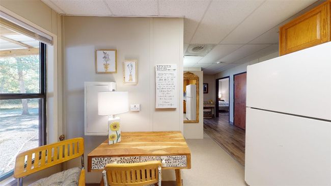 Corridor with a paneled ceiling and light wood-style floors | Image 8