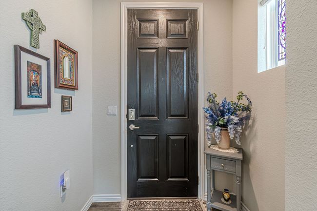 Entrance foyer featuring wood finished floors and a textured wall | Image 7