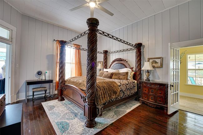 Bedroom with ceiling fan, lofted ceiling, hardwood / wood-style floors, and baseboards | Image 20