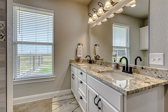 Primary bathroom featuring a walk-in shower and double vanity | Image 24