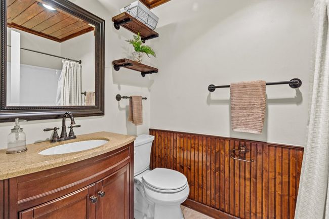 The full guest bathroom is equipped with a tub/shower combo and functional storage, making it convenient for both daily use and visitors. | Image 24