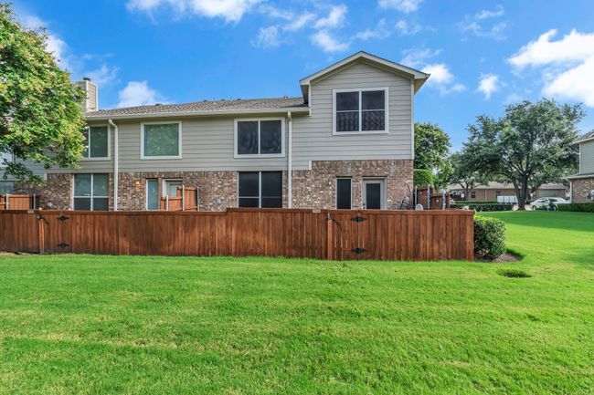 Back of house with a chimney, brick siding, and a gate | Image 28