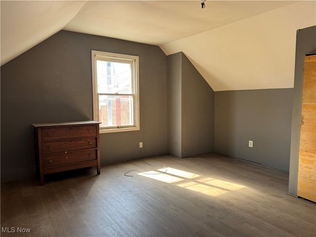 Bonus room featuring vaulted ceiling and wood finished floors | Image 25