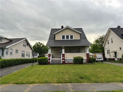 View of front of property with covered porch and a front lawn | Image 1