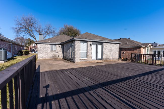 Wooden terrace with central air condition unit and a residential view | Image 23