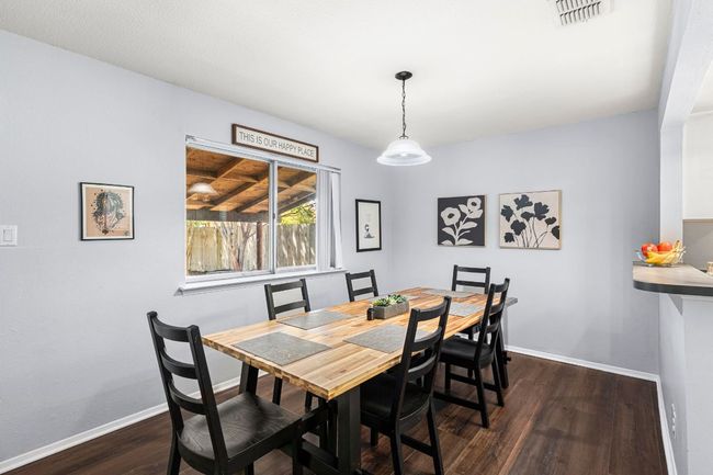 Dining room with dark wood-type flooring and baseboards | Image 10